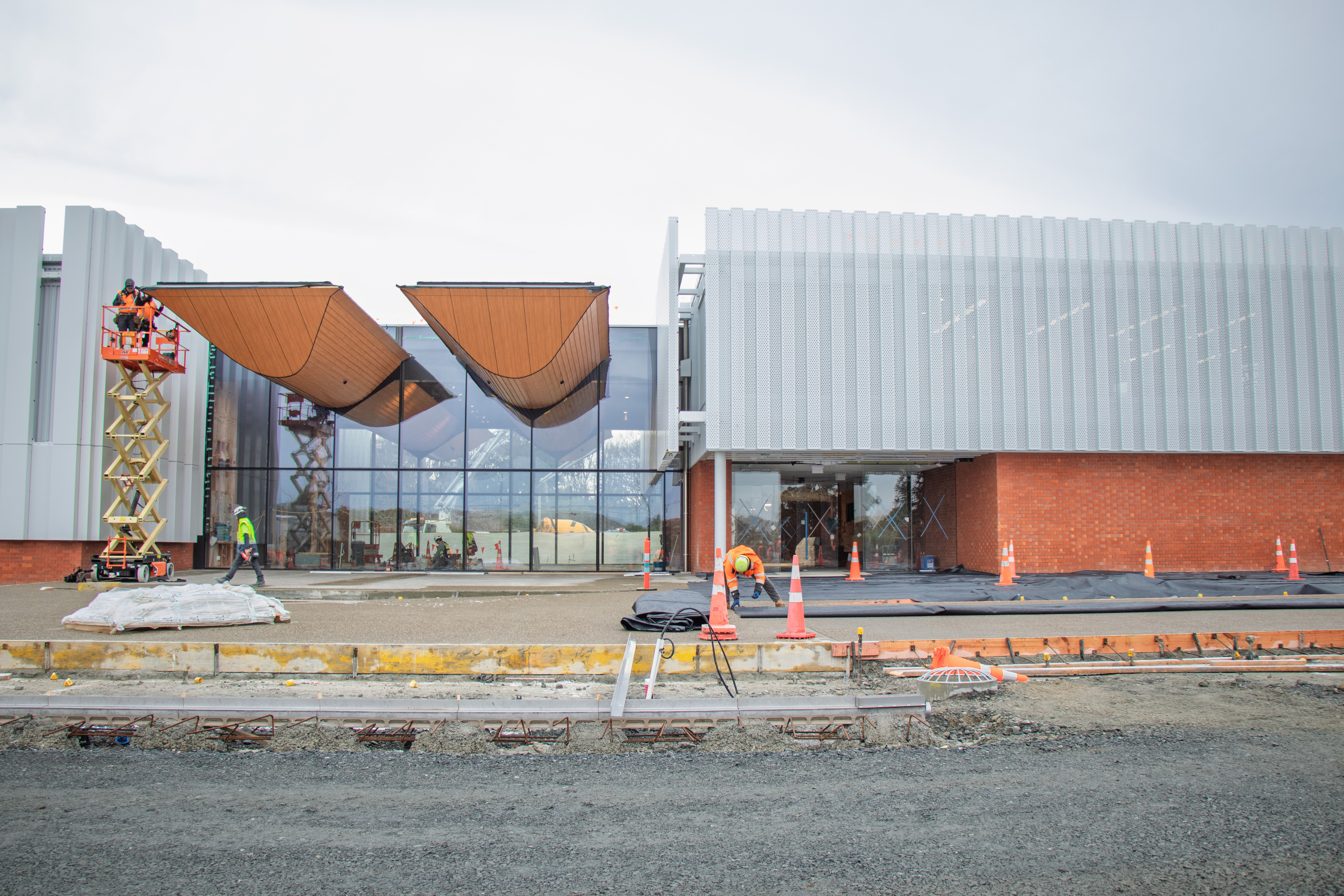 The entranceway to Te Unua Museum of Southland features a double-hulled waka hanging above the foyer. Outside, a new pathway leading to the entrance is under construction.